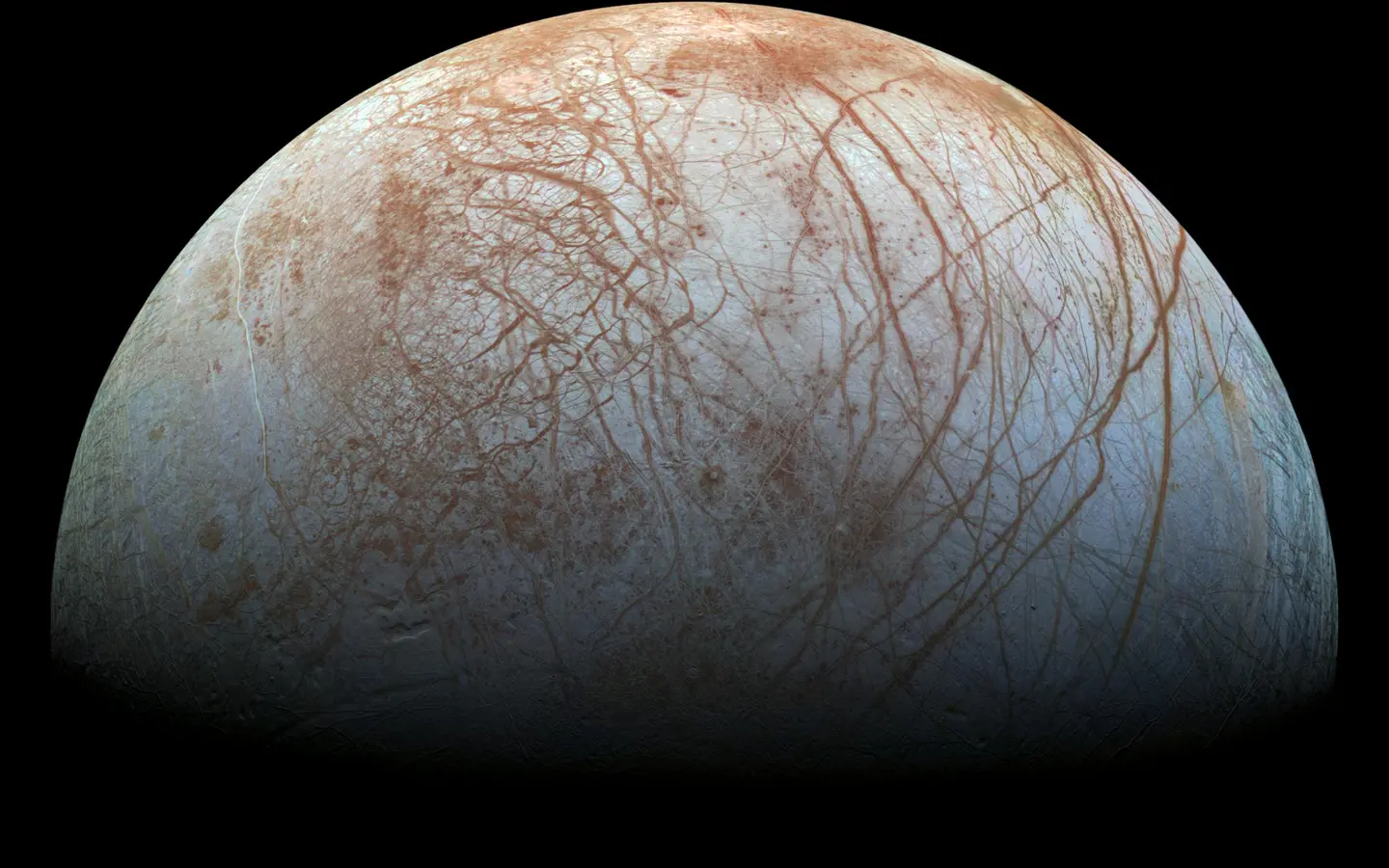 Spacecraft image showing Europa's fractured icy surface